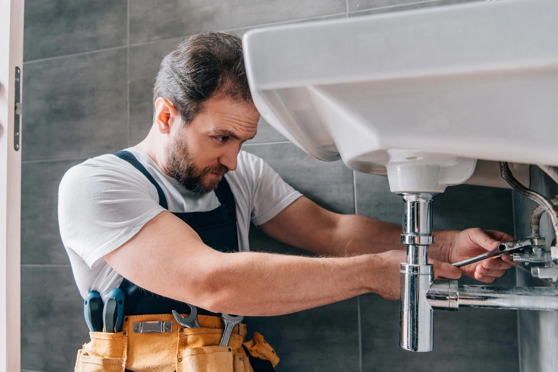 Plumber Fixing Bathroom Sink Image