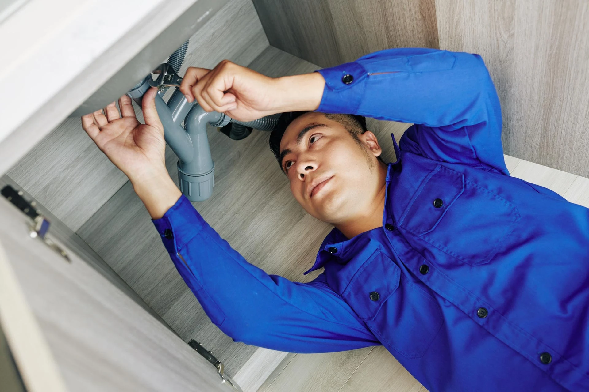 Plumber under sink image
